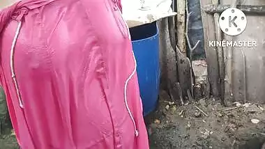 Indian house wife bathing outside