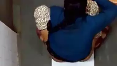 Indian girl changing pad in toilet